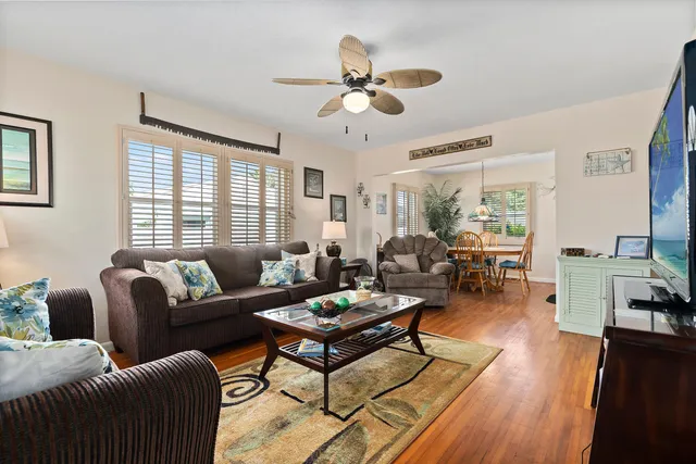 a living room with furniture ceiling fan and a window