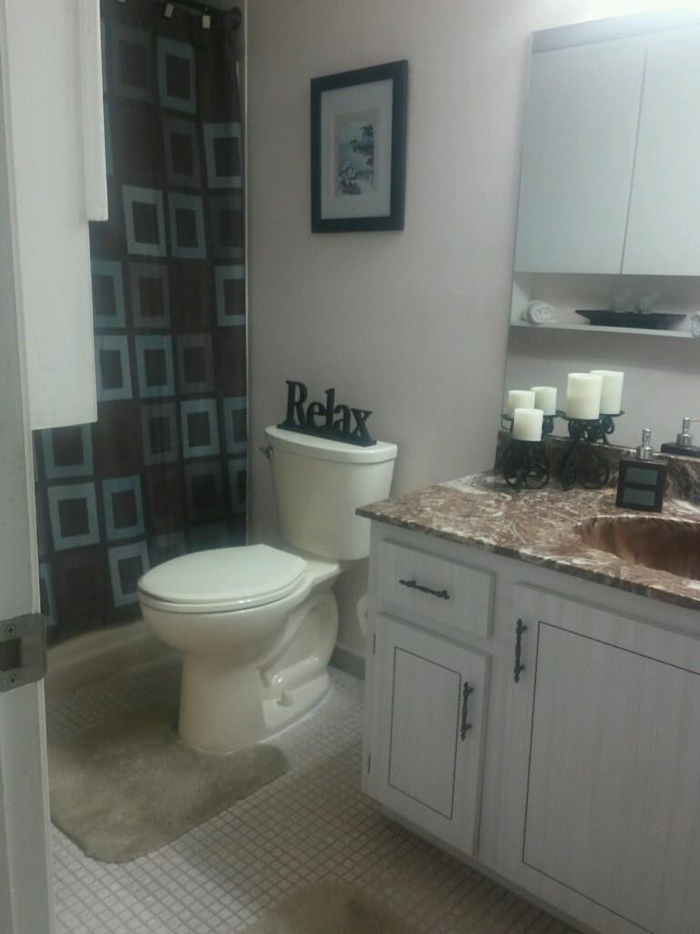3571 Inverrary Drive, Unit 308 Lauderhill, FL 33319 - Photo 3 of 9 a white toilet sitting next to a bathroom sink