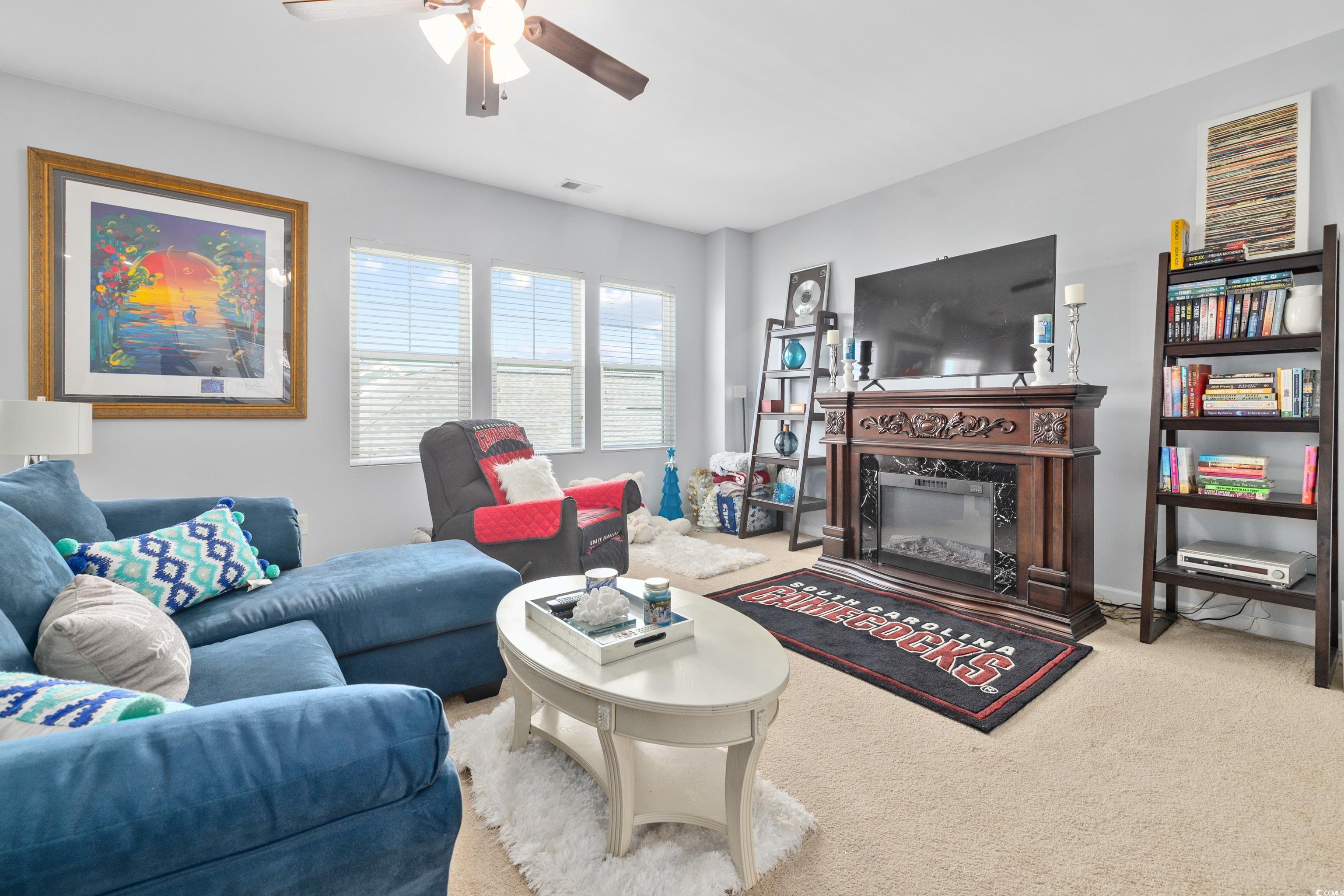 2360 Heritage Loop, Unit 2360 Myrtle Beach, SC 29577 - Photo 28 of 38 Carpeted living area with a fireplace and ceiling fan