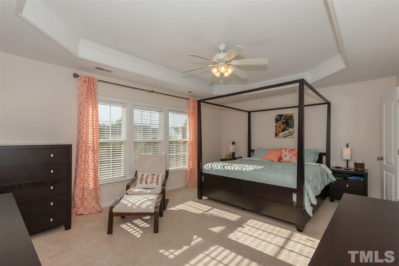 7613 Silver View Lane Raleigh, NC 27613 - Photo 13 of 25 The huge light-filled master bedroom feautres neutral decor and a beautiful tray ceiling.