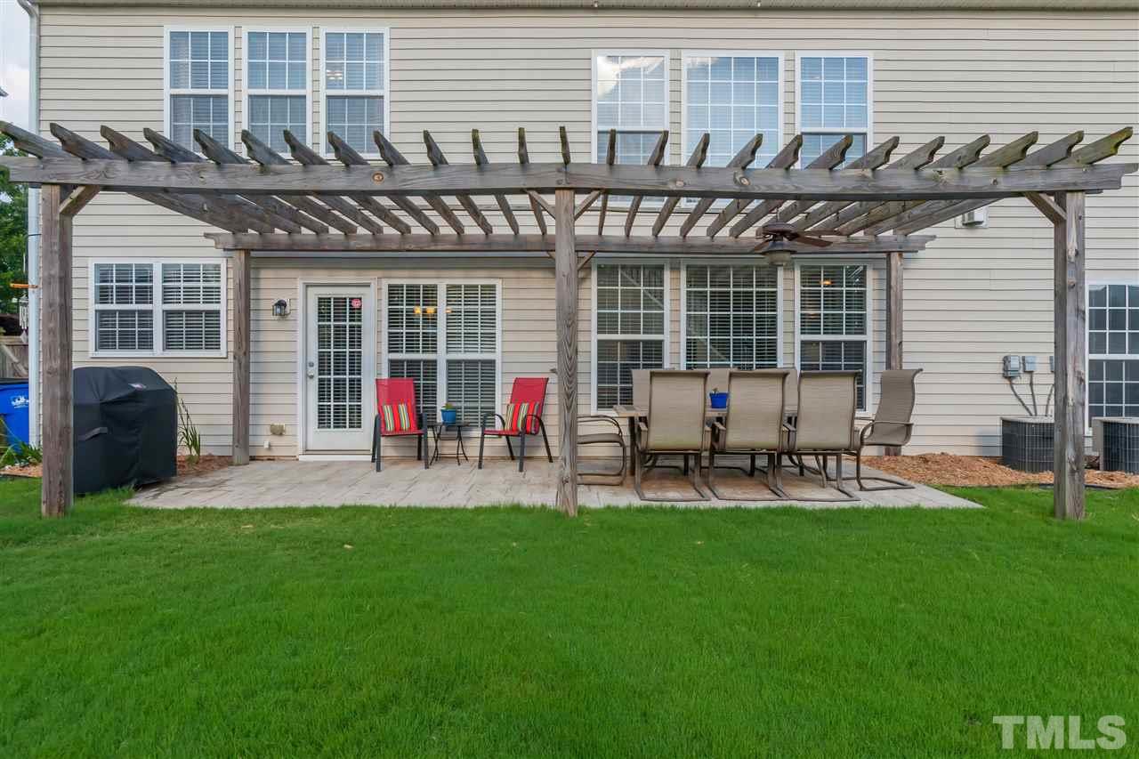 7613 Silver View Lane Raleigh, NC 27613 - Photo 20 of 25 Outdoor entertaining at its best! Huge stone patio and pergola with fan allow you to spend time outside with friends all year long!