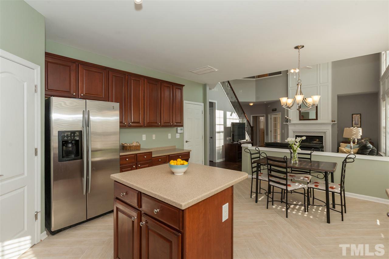7613 Silver View Lane Raleigh, NC 27613 - Photo 6 of 25 The kitchen features ceramic tile planks laid in a herringbone pattern, a huge island, upgraded cherry cabinets, stainless appliances, and a gigantic pantry.
