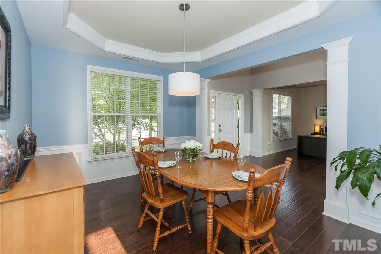 7613 Silver View Lane Raleigh, NC 27613 - Photo 8 of 25 Formal dining room that's large enough for extended family features the same gorgeous wide-plank hardwood floors found throughout first floor.