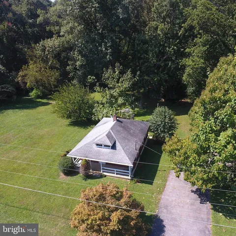 a front view of a house with a garden and yard