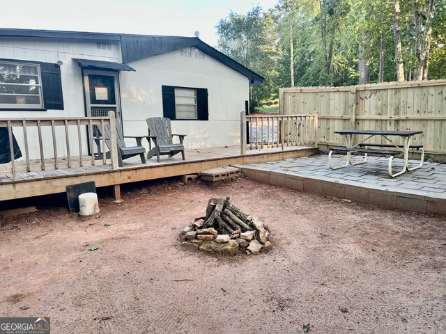a view of a chairs and table in the backyard