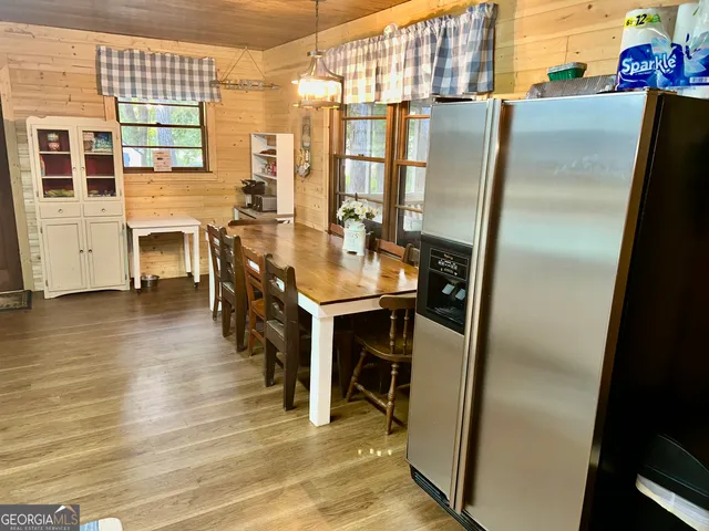 a kitchen with stainless steel appliances kitchen island granite countertop furniture and a microwave