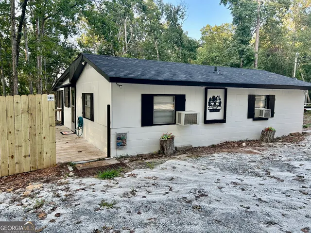 a backyard of a house with barbeque oven and outdoor seating