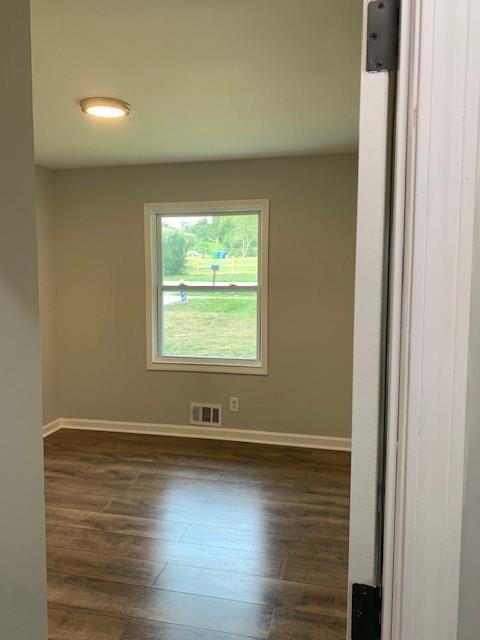 4559 Hendrix Drive Forest Park, GA 30297 - Photo 17 of 24 an empty room with wooden floor and windows