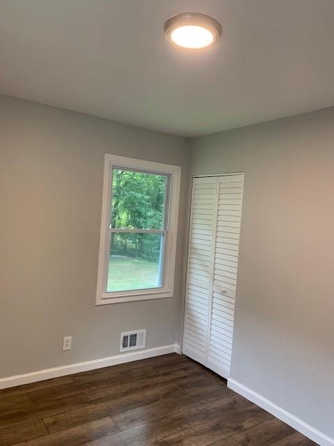 4559 Hendrix Drive Forest Park, GA 30297 - Photo 19 of 24 an empty room with wooden floor and windows