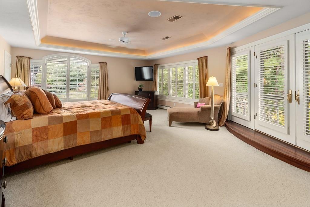 7 Pettees Pond Lane Walpole, MA 02081 - Photo 16 of 38 a bedroom with bed couch and large window
