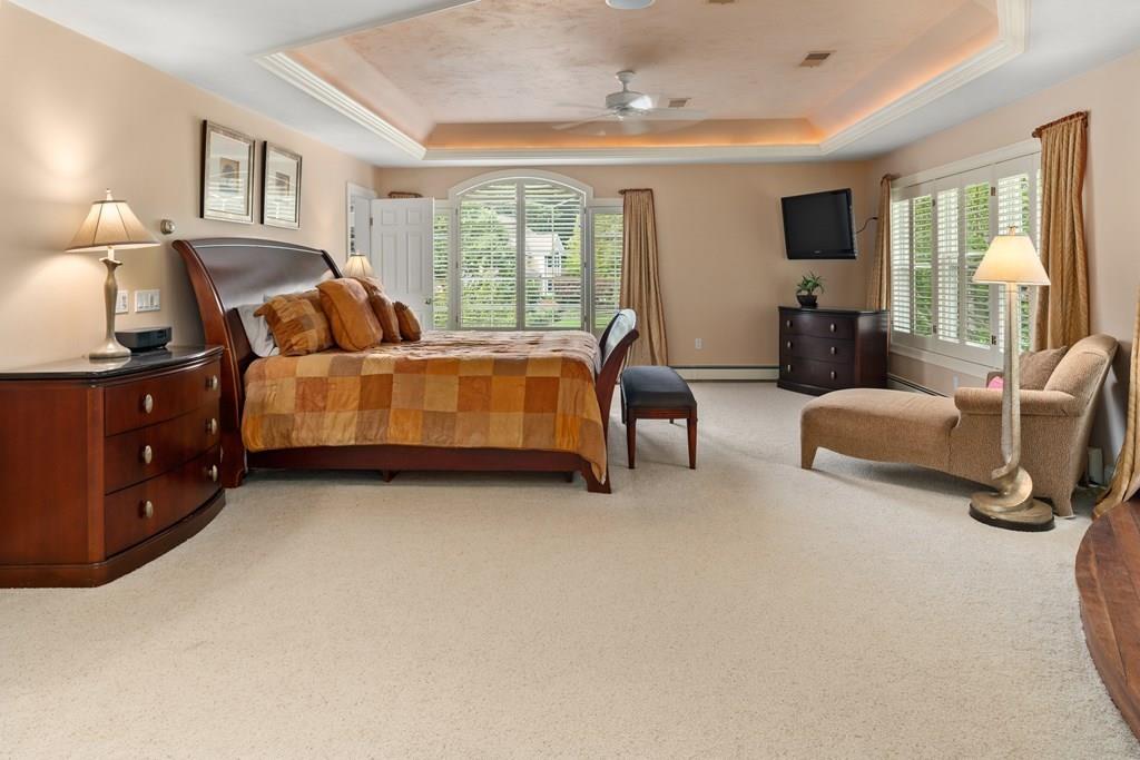 7 Pettees Pond Lane Walpole, MA 02081 - Photo 17 of 38 a spacious bedroom with a bed and wooden floor