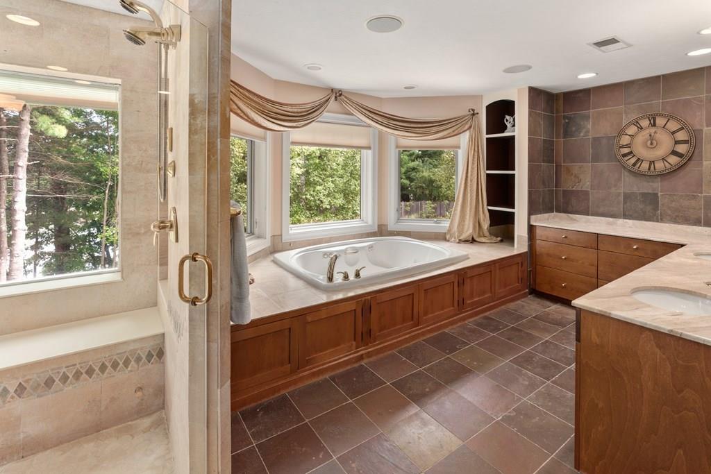 7 Pettees Pond Lane Walpole, MA 02081 - Photo 18 of 38 a bathroom with a tub and a large window