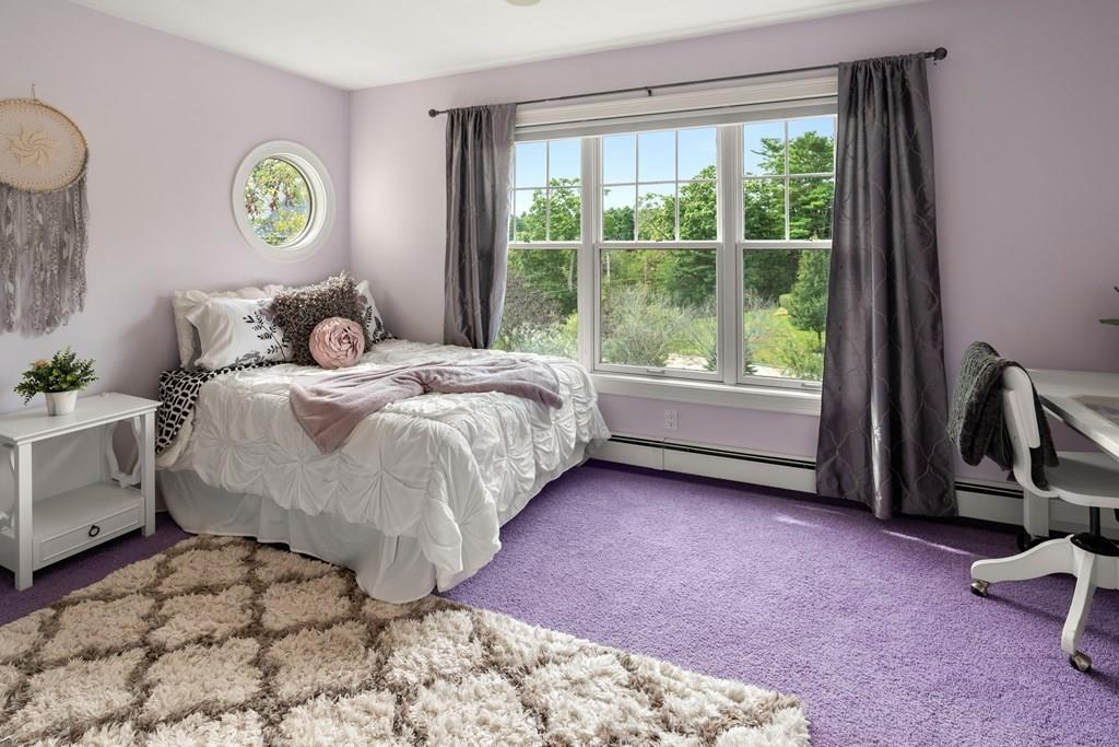 7 Pettees Pond Lane Walpole, MA 02081 - Photo 20 of 38 a bed sitting in a bedroom next to a window