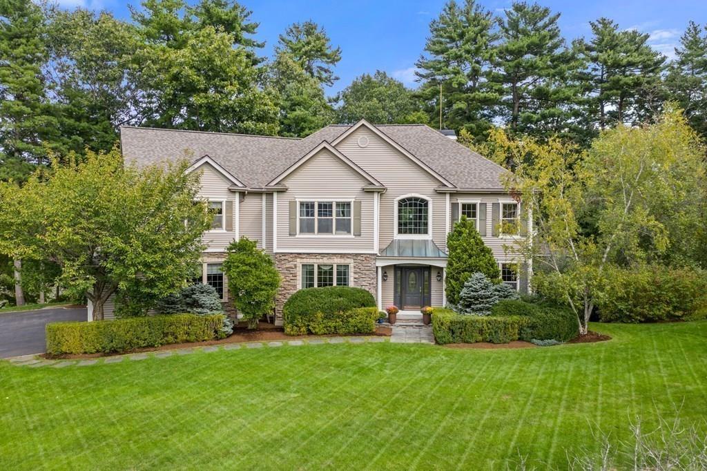 7 Pettees Pond Lane Walpole, MA 02081 - Photo 2 of 38 a front view of a house with a yard and trees
