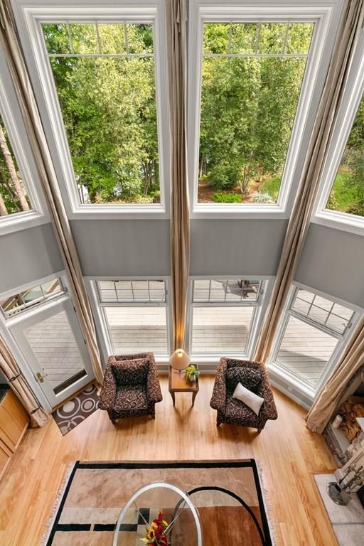 7 Pettees Pond Lane Walpole, MA 02081 - Photo 24 of 38 a view of a living room with furniture and floor to ceiling windows
