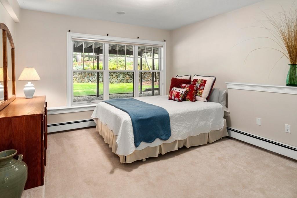 7 Pettees Pond Lane Walpole, MA 02081 - Photo 28 of 38 a bedroom with a bed and a large window