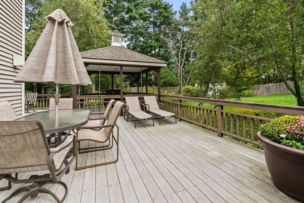 7 Pettees Pond Lane Walpole, MA 02081 - Photo 29 of 38 an outdoor space with furniture and umbrella