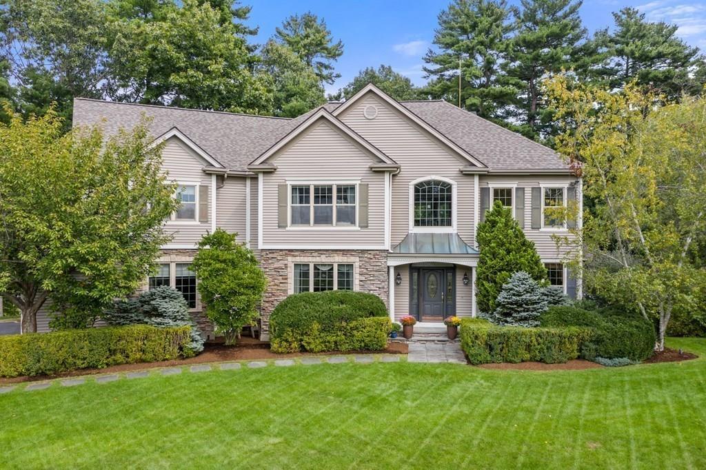 7 Pettees Pond Lane Walpole, MA 02081 - Photo 38 of 38 a front view of a house with a yard and garage