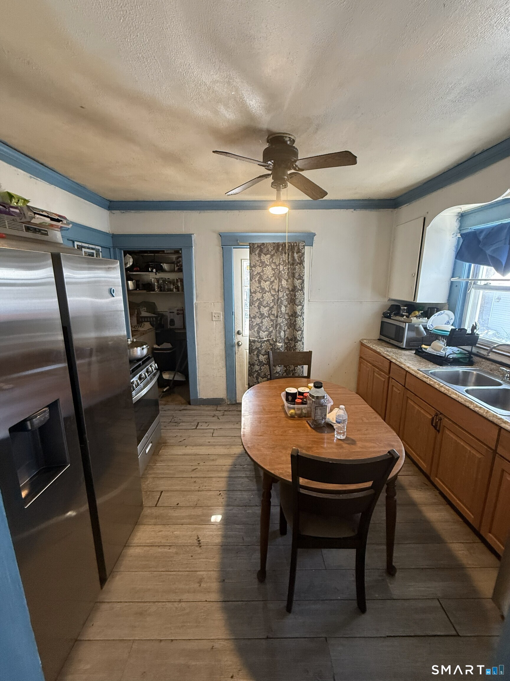 75 Frank Street Stamford, CT 06902 - Photo 5 of 21 a dining room with a wooden table and chairs