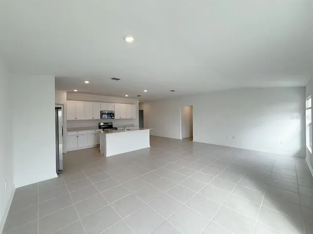 a view of kitchen with kitchen island sink and stove