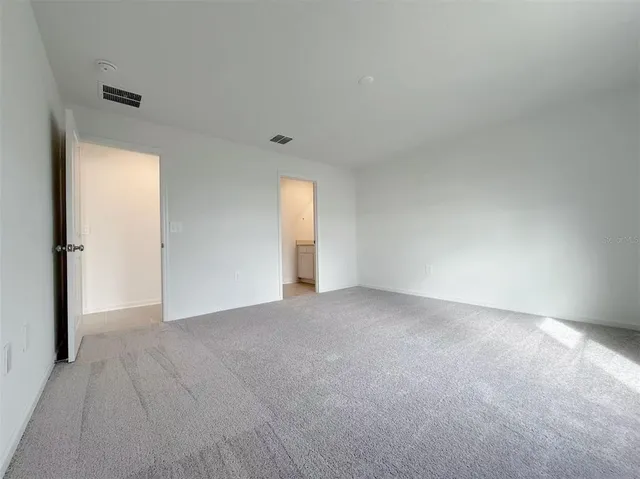 a view of an empty room and a window