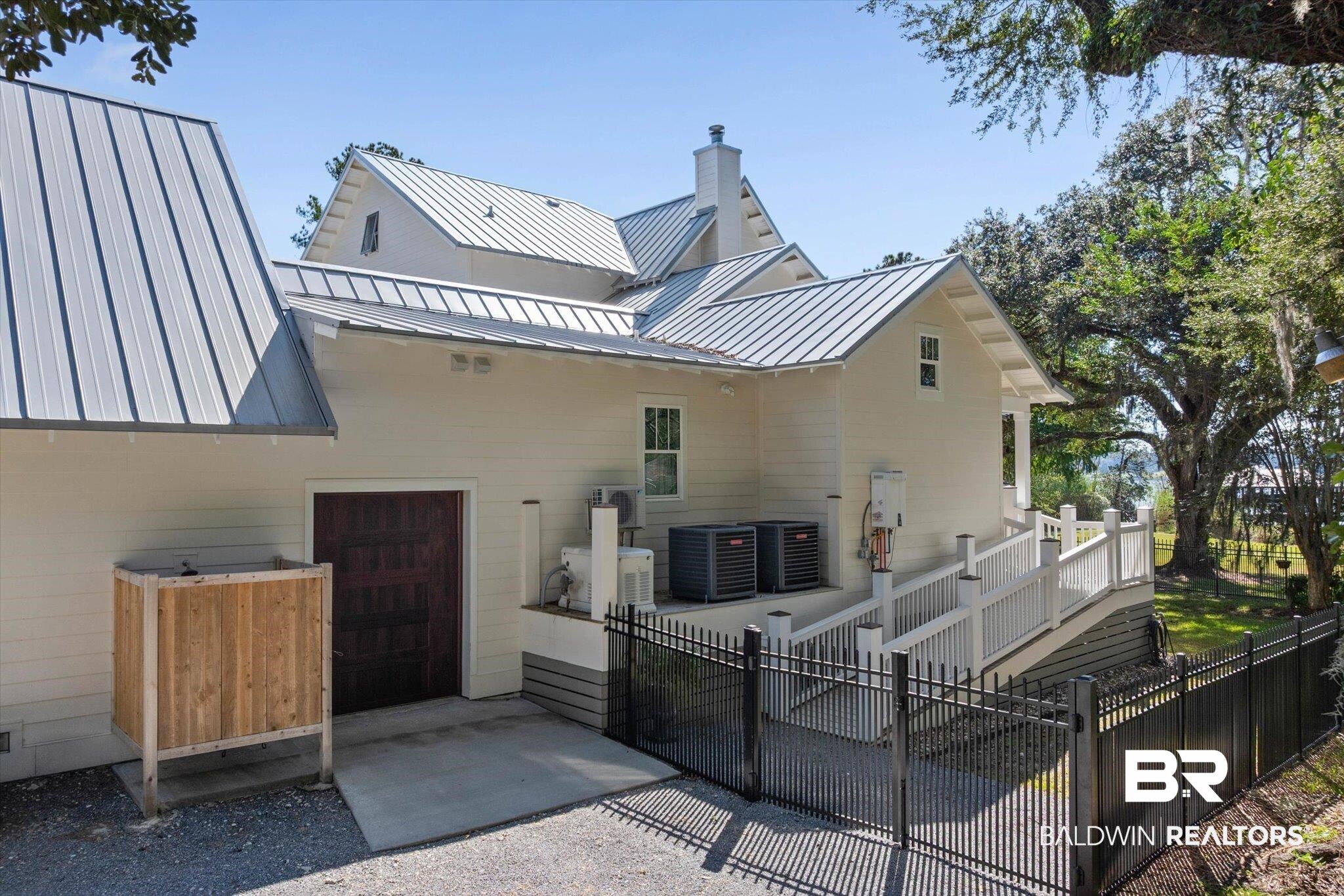 2415 Venetia Road Mobile, AL 36605 - Photo 44 of 50 Rear view of property with a metal roof, a deck, and a chimney