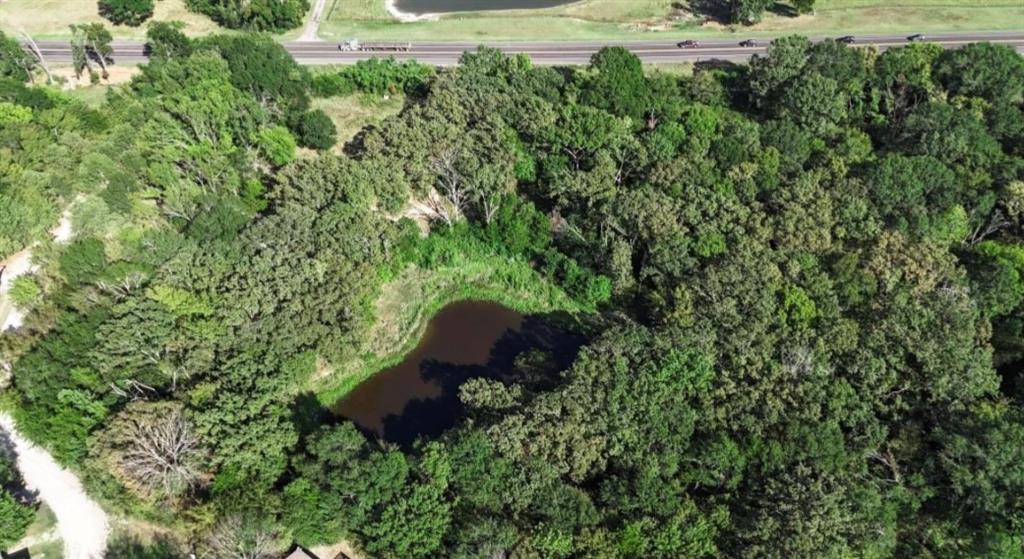 Aerial view of property and surrounding area featuring a nearby body of water