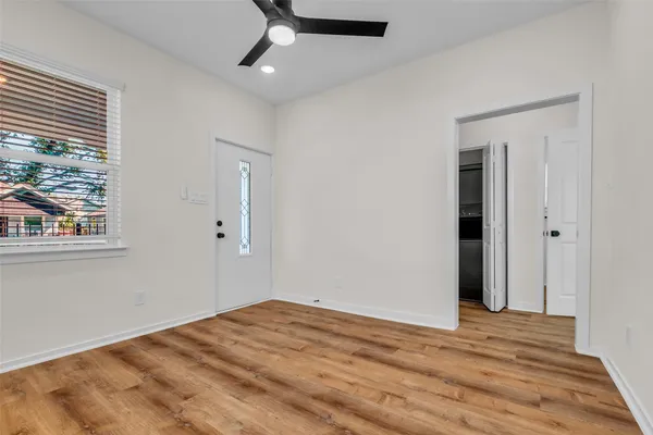 a kitchen with white cabinets and a window