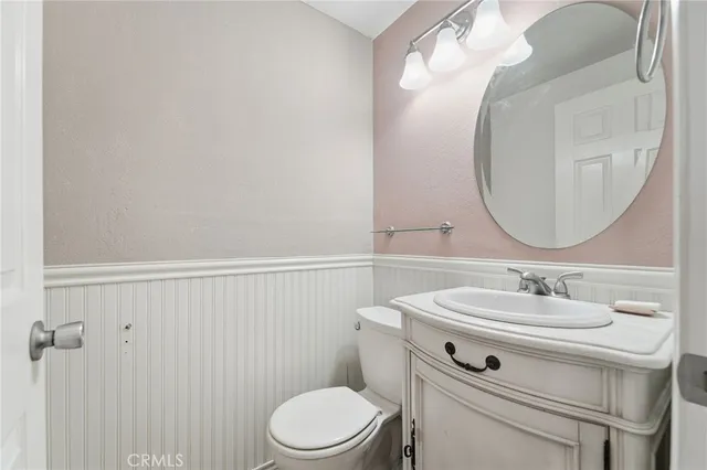 a bathroom with a sink toilet and a mirror