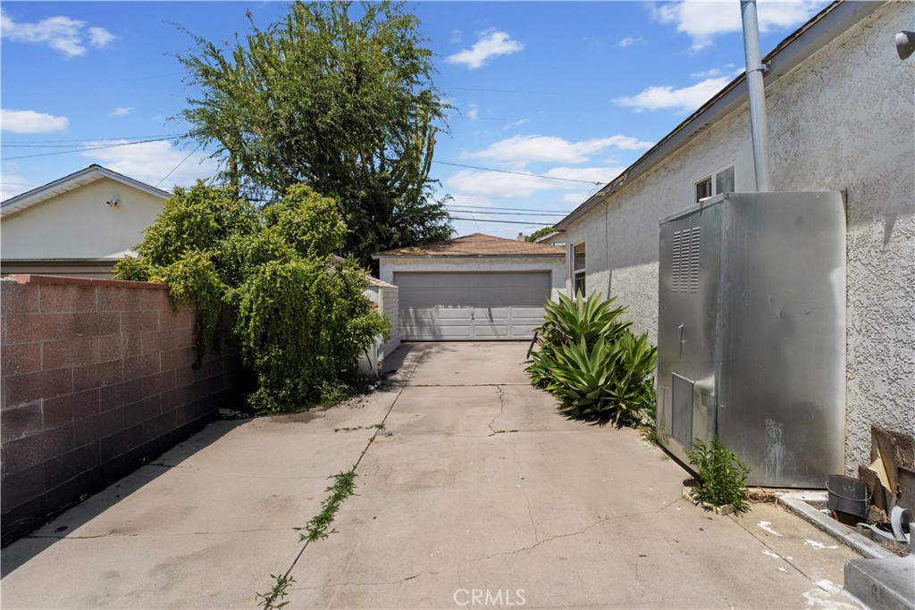 2725 East Tyler Street Carson, CA 90810 - Photo 22 of 30 a view of a house with a yard and garage