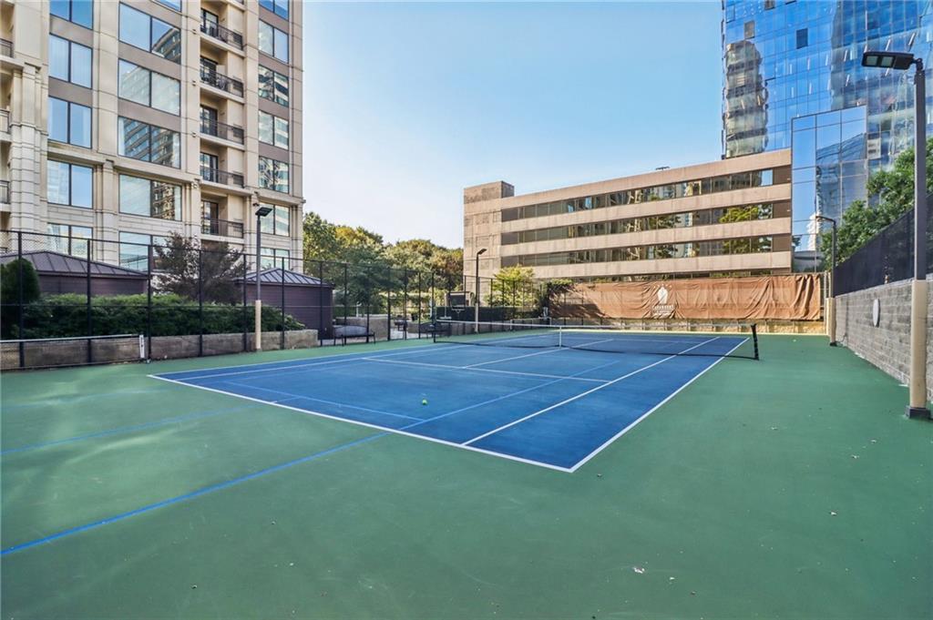 3445 Stratford Road Northeast, Unit 2602 Atlanta, GA 30326 - Photo 12 of 56 a view of a tennis ground with large buildings