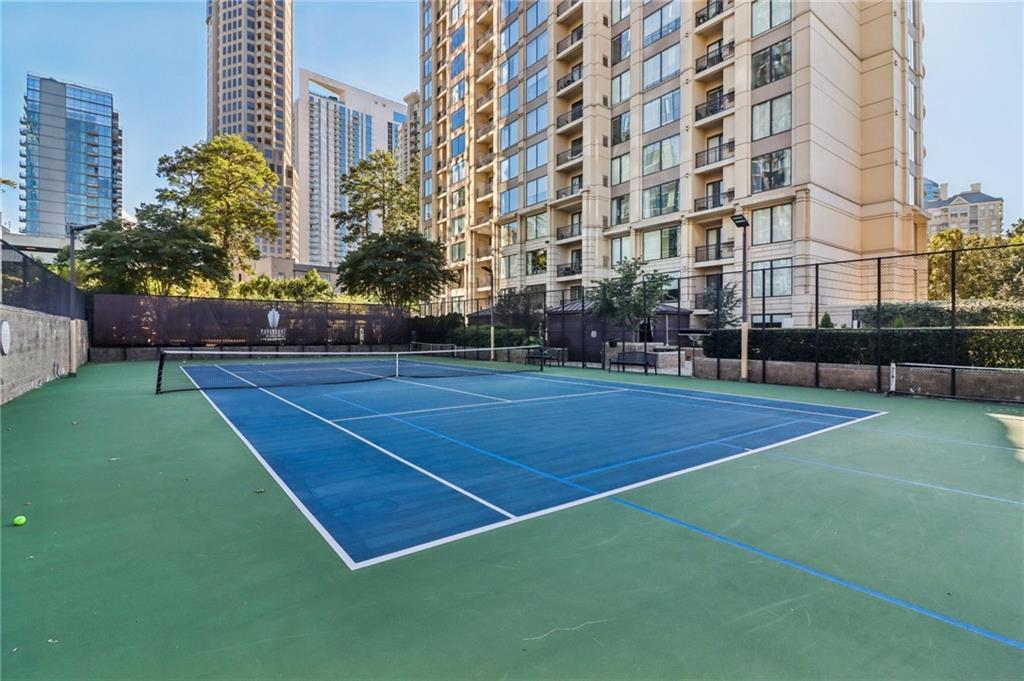 3445 Stratford Road Northeast, Unit 2602 Atlanta, GA 30326 - Photo 13 of 56 a view of a tennis ground with large trees