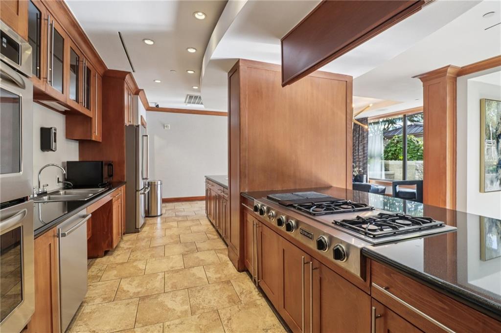 3445 Stratford Road Northeast, Unit 2602 Atlanta, GA 30326 - Photo 21 of 56 a kitchen with stainless steel appliances granite countertop a stove and a sink
