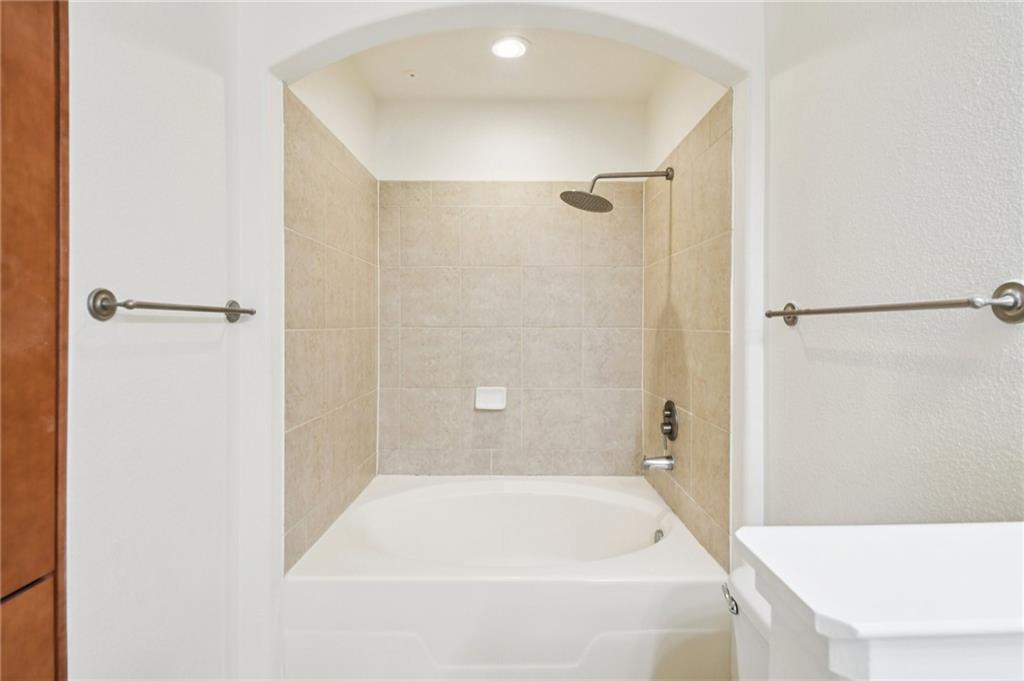 3445 Stratford Road Northeast, Unit 2602 Atlanta, GA 30326 - Photo 29 of 56 a bathroom with a tub and shower