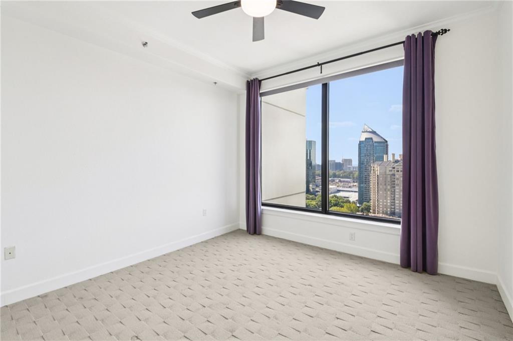 3445 Stratford Road Northeast, Unit 2602 Atlanta, GA 30326 - Photo 33 of 56 a view of a room with a large window and chandelier fan