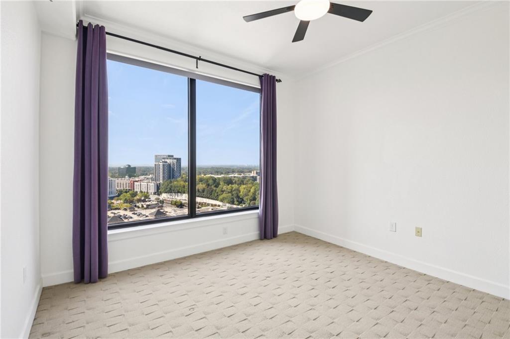 3445 Stratford Road Northeast, Unit 2602 Atlanta, GA 30326 - Photo 34 of 56 an empty room with a large window and a ceiling fan