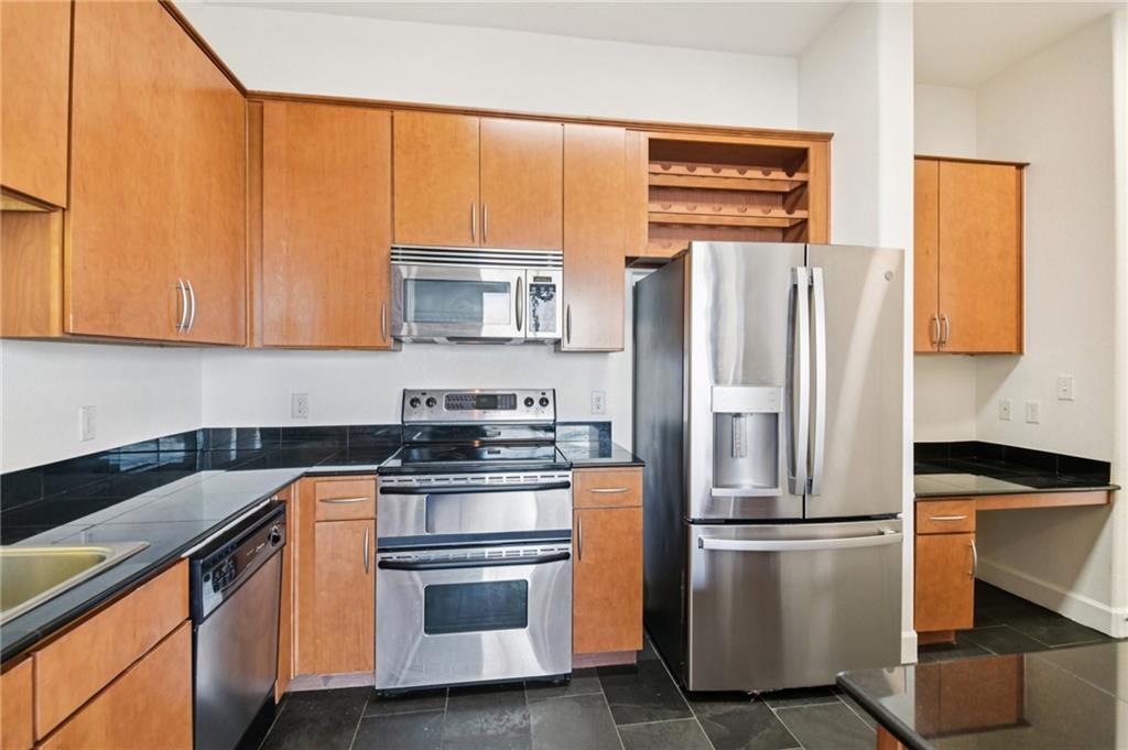 3445 Stratford Road Northeast, Unit 2602 Atlanta, GA 30326 - Photo 39 of 56 a kitchen with stainless steel appliances a refrigerator sink and microwave
