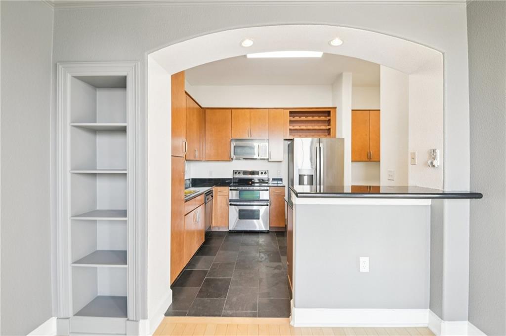 3445 Stratford Road Northeast, Unit 2602 Atlanta, GA 30326 - Photo 41 of 56 a kitchen with stainless steel appliances a refrigerator sink and cabinets