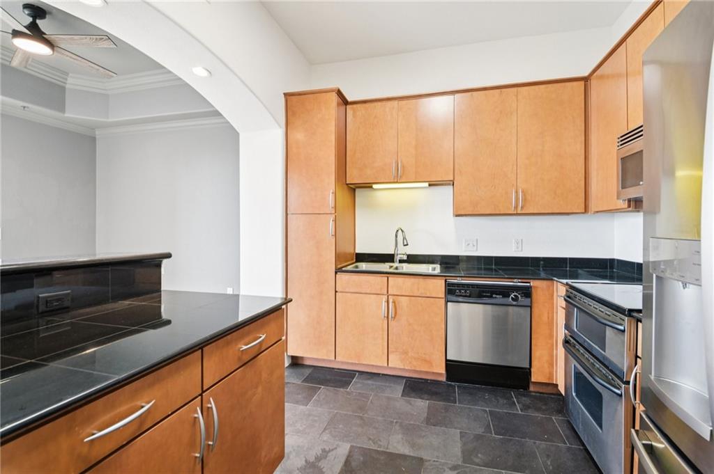 3445 Stratford Road Northeast, Unit 2602 Atlanta, GA 30326 - Photo 43 of 56 a kitchen with granite countertop white cabinets and stainless steel appliances