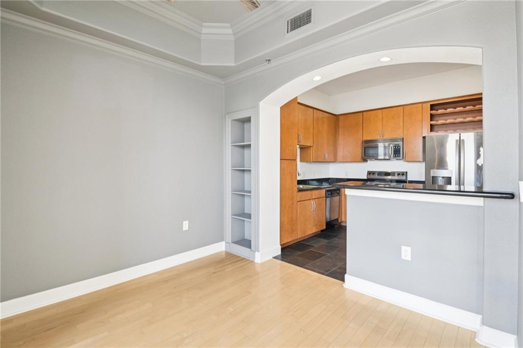 3445 Stratford Road Northeast, Unit 2602 Atlanta, GA 30326 - Photo 44 of 56 a kitchen with stainless steel appliances a refrigerator and a stove