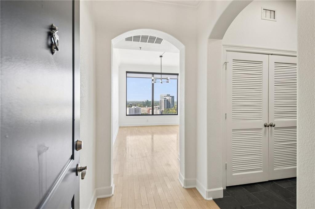 3445 Stratford Road Northeast, Unit 2602 Atlanta, GA 30326 - Photo 47 of 56 a view of a hallway with closet and wooden floor