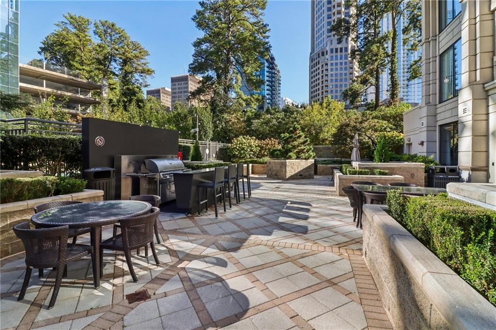 3445 Stratford Road Northeast, Unit 2602 Atlanta, GA 30326 - Photo 6 of 56 a view of a patio with a table and chairs and potted plants