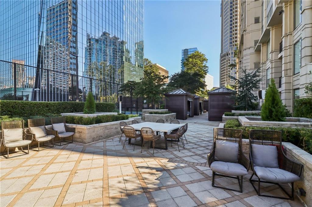 3445 Stratford Road Northeast, Unit 2602 Atlanta, GA 30326 - Photo 10 of 56 a view of a patio with couches table and chairs and potted plants