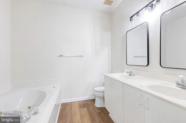 a white bath tub sitting next to a shower