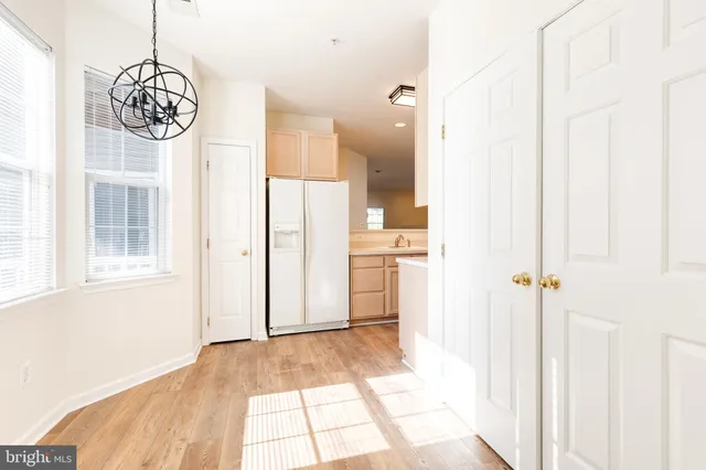 a view of a hallway with a dining table chairs and entryway