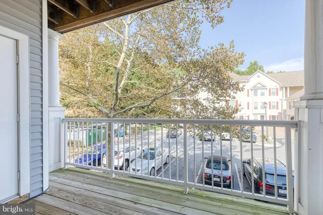 a view of balcony with wooden floor and fence