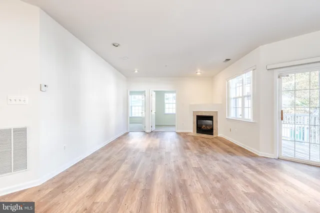 a view of a livingroom with wooden floor and fireplace