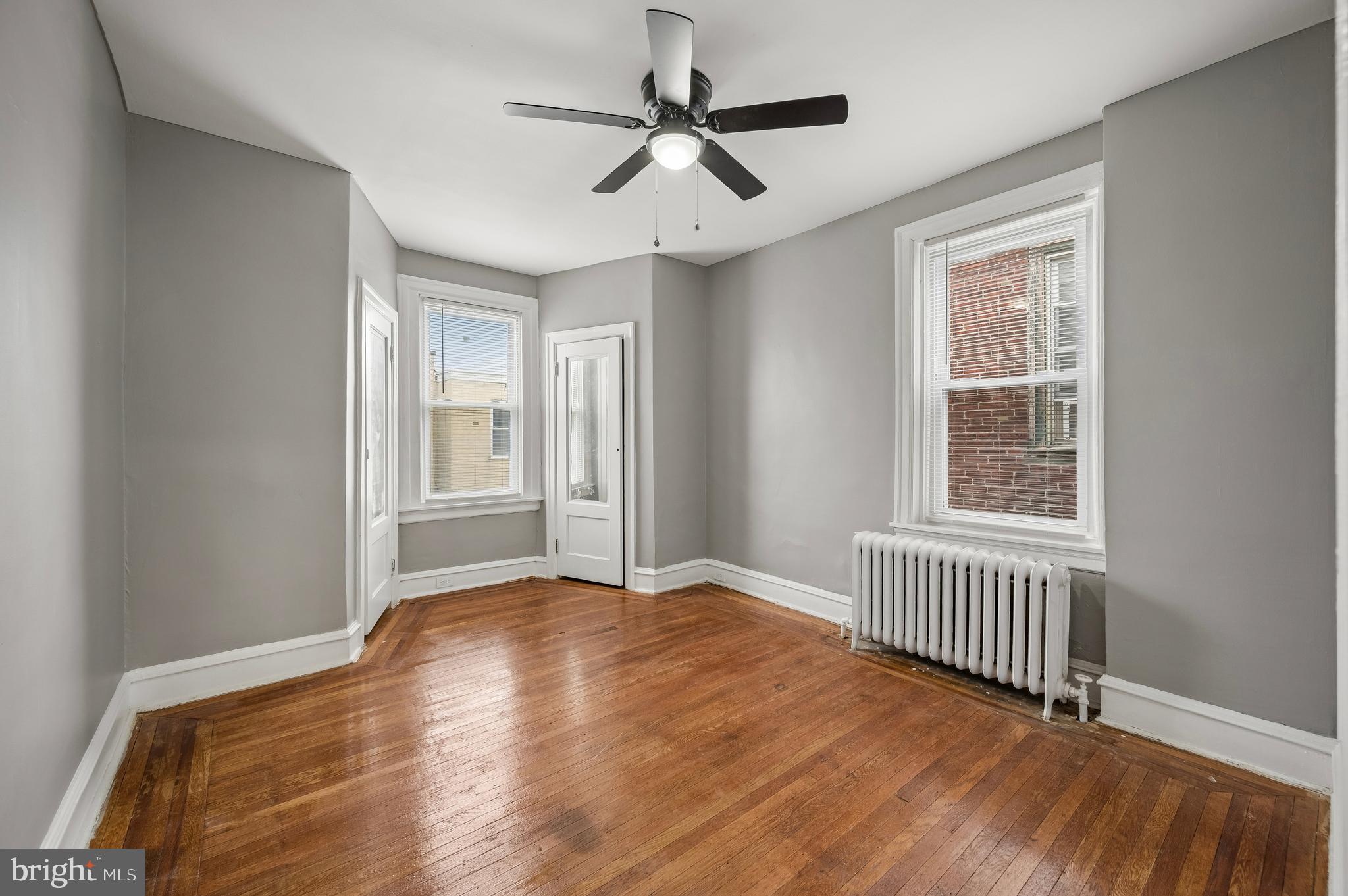 5625 Willows Avenue Philadelphia, PA 19143 - Photo 11 of 15 a view of an empty room with a window and wooden floor