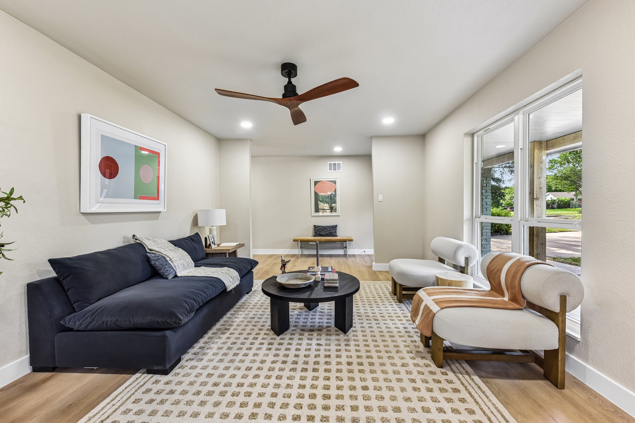 7523 Glenhill Road Austin, TX 78752 - Photo 7 of 38 Natural light streams into this living area, featuring rich hardwood floors and recessed lighting.