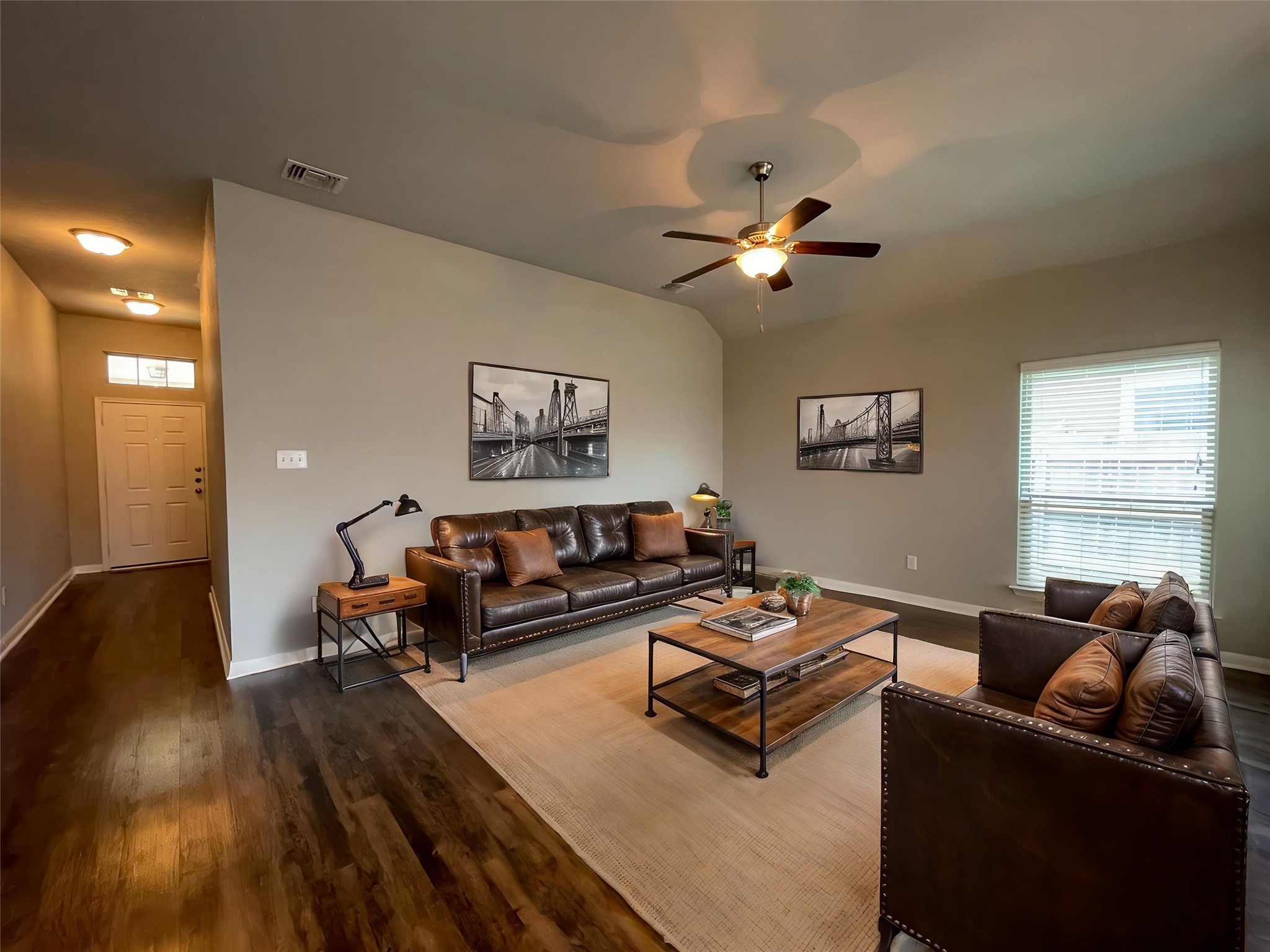 8113 Northgate Loop Temple, TX 76502 - Photo 2 of 35 Spacious living area featuring wood-finish flooring, vaulted ceilings, a ceiling fan, and large windows with blinds